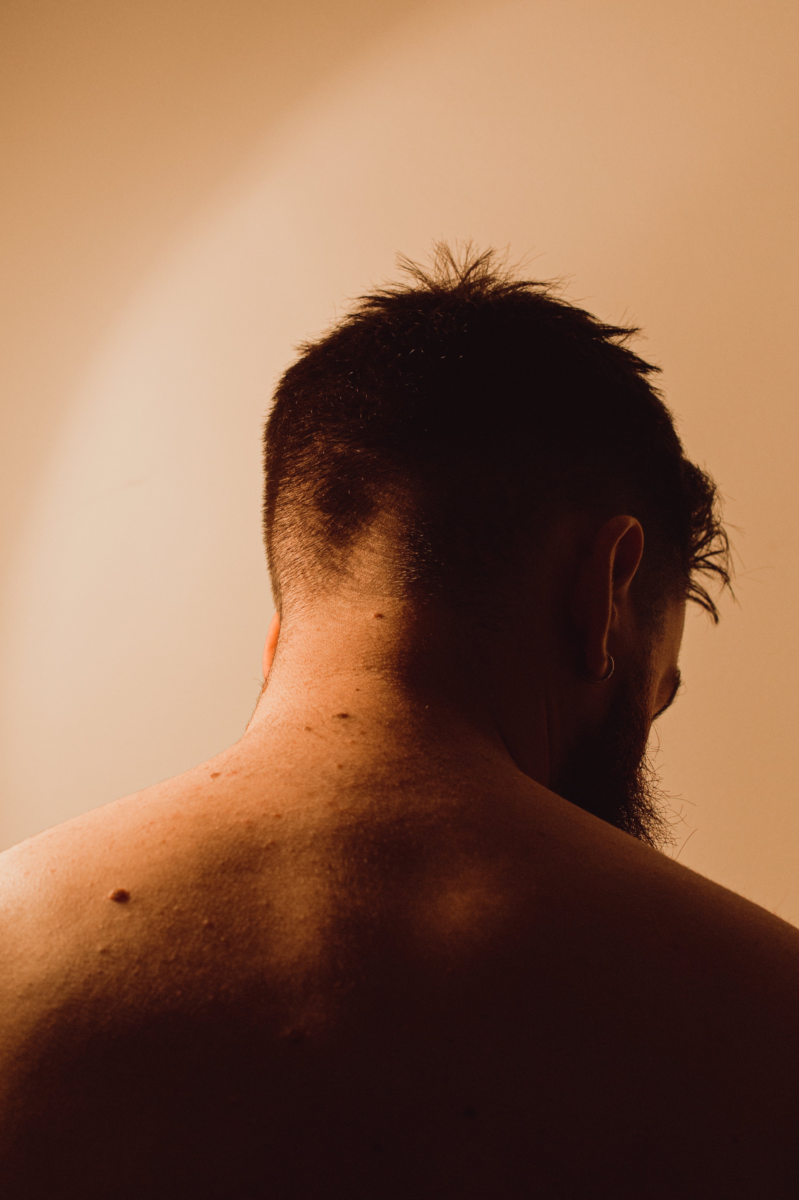 back-of-a-persons-head-as-they-lower-it-in-reflection.jpg